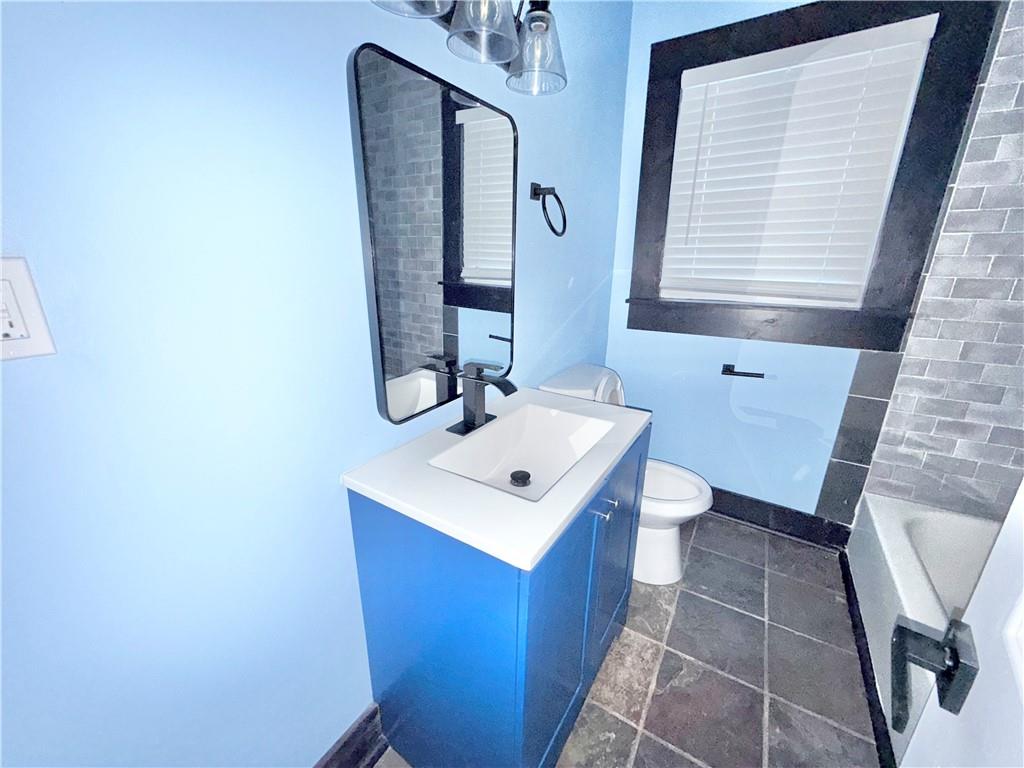 1802 South Gordon Street Southwest Atlanta, GA 30310 - Photo 9 of 14 a bathroom with a sink toilet and mirror