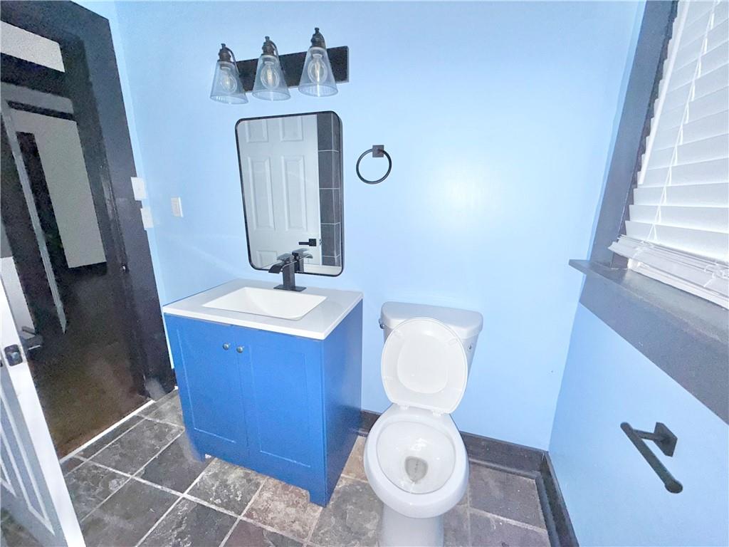 1802 South Gordon Street Southwest Atlanta, GA 30310 - Photo 10 of 14 a bathroom with a toilet sink and mirror