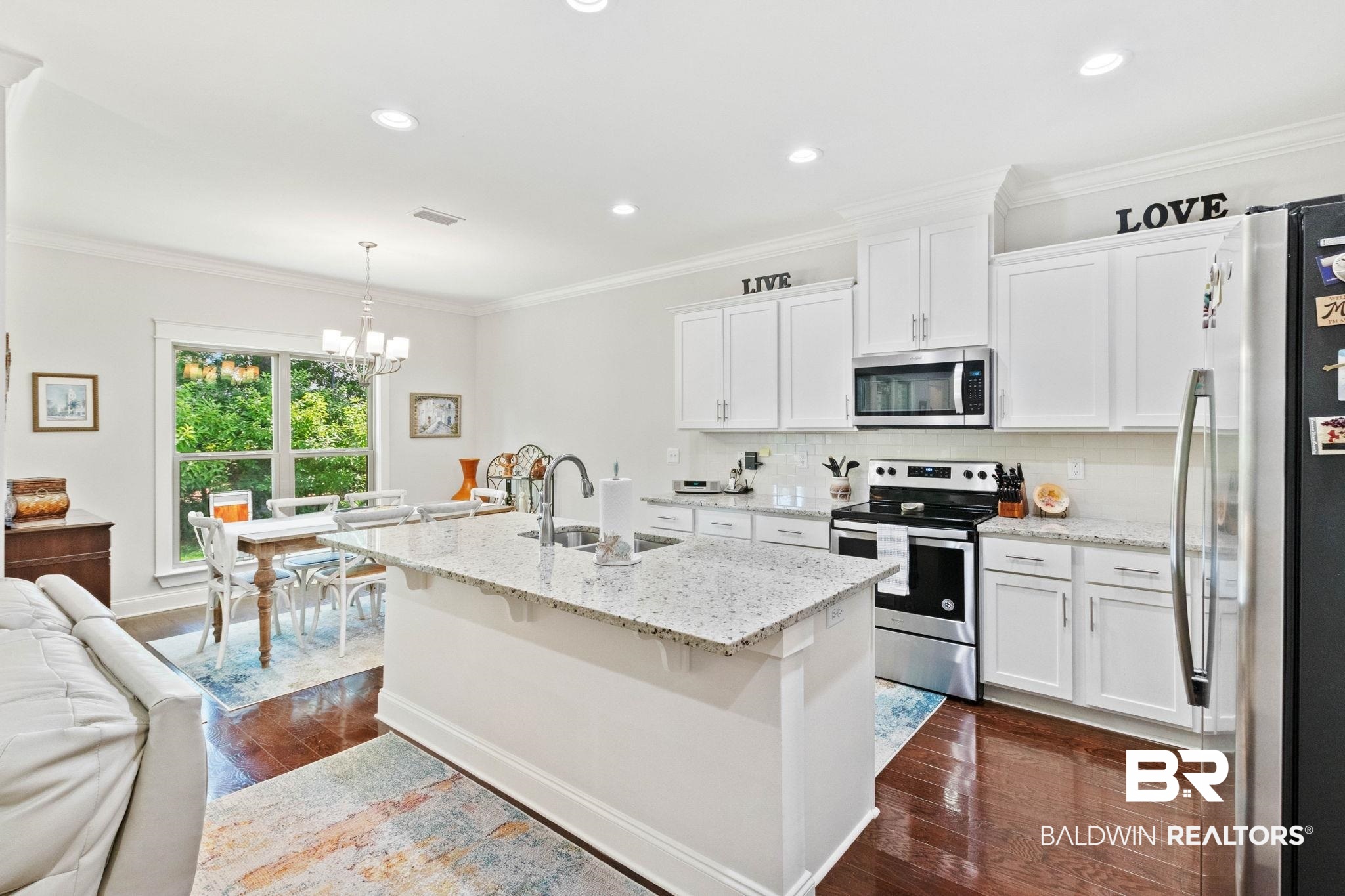 192 Mark Twain Loop Foley, AL 36535 - Photo 8 of 42 Kitchen with white cabinetry, pendant lighting, sink, dark hardwood / wood-style floors, and appliances with stainless steel finishes