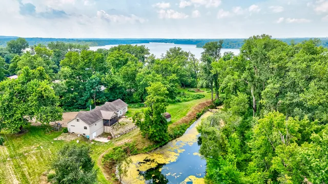 an aerial view of a house with yard