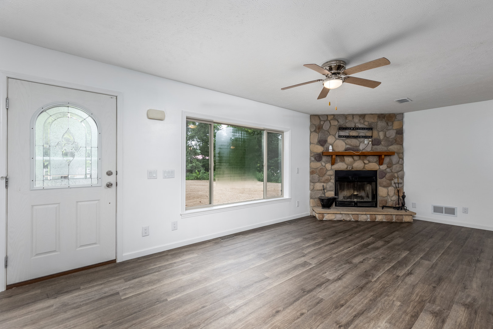 931 Highway 26 Magnolia, IL 61336 - Photo 6 of 35 a view of an empty room with a window and wooden floor