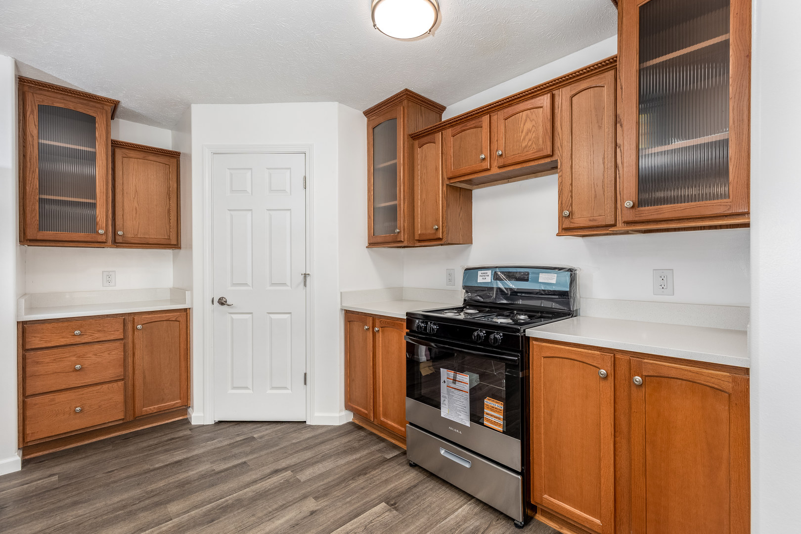 931 Highway 26 Magnolia, IL 61336 - Photo 10 of 35 a kitchen with granite countertop wooden cabinets and a stove top oven