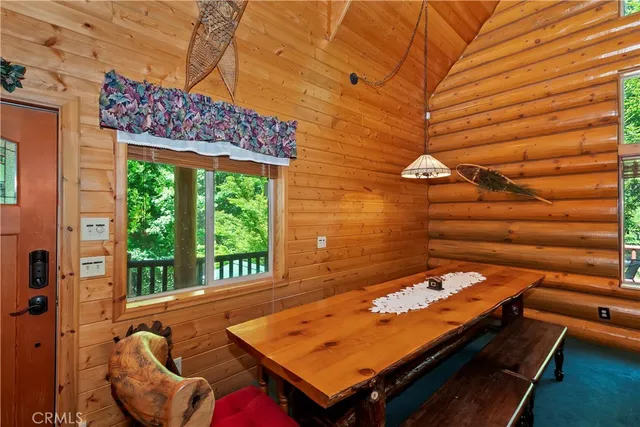 a bedroom with a bed a dresser next to a window