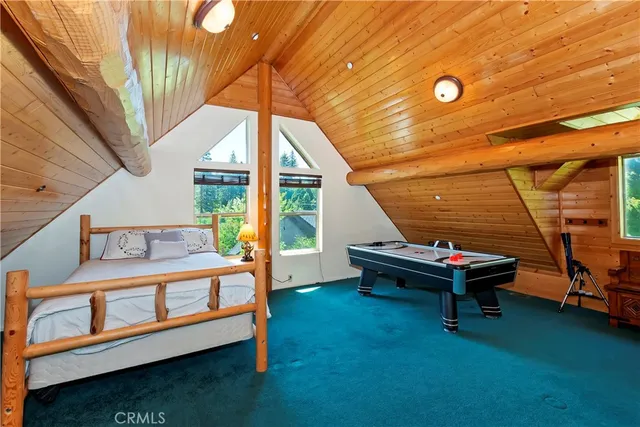 a bedroom with a bed and windows