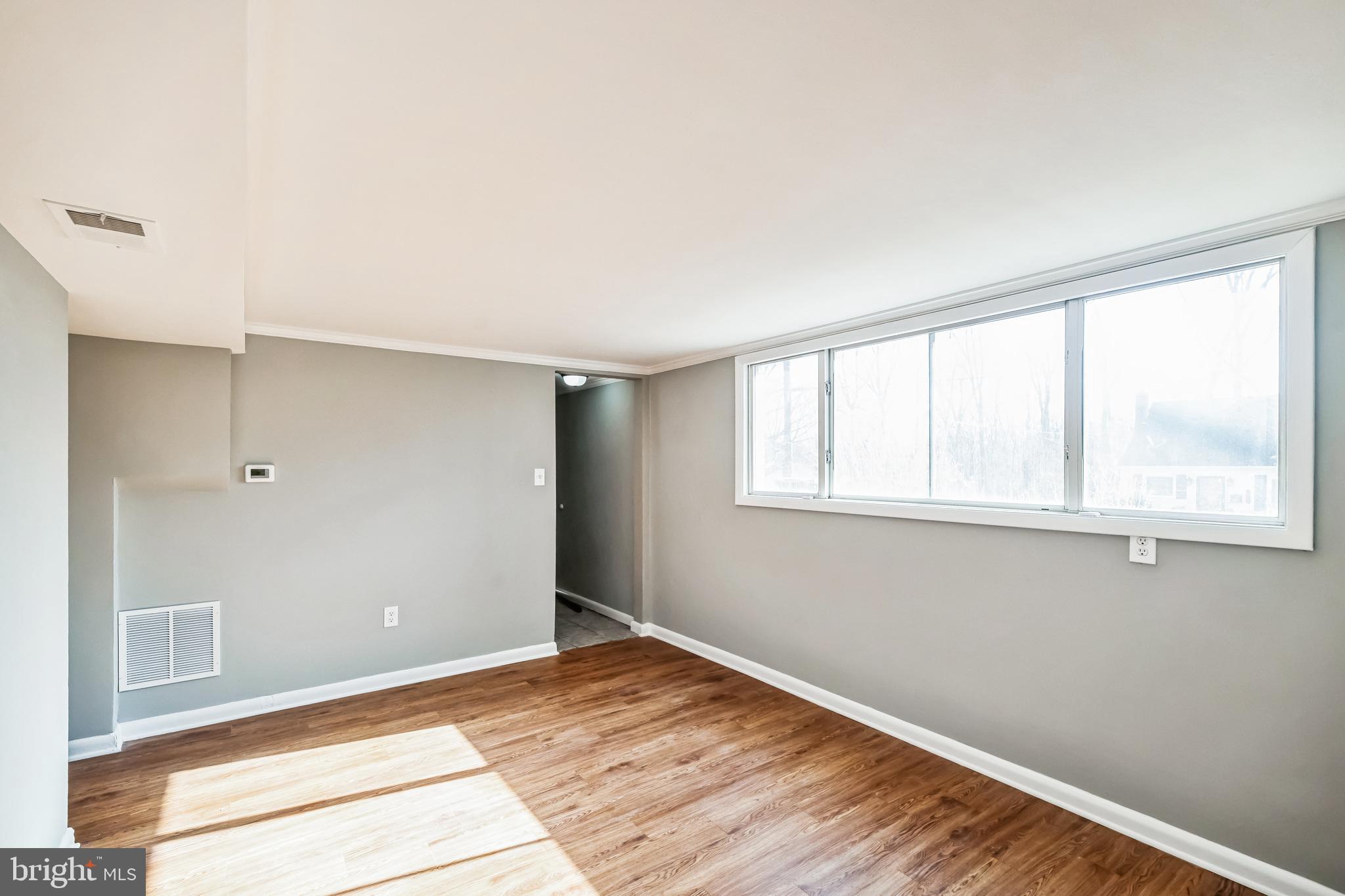 13426 Greenacre Drive Woodbridge, VA 22191 - Photo 13 of 45 a view of an empty room with wooden floor and a window