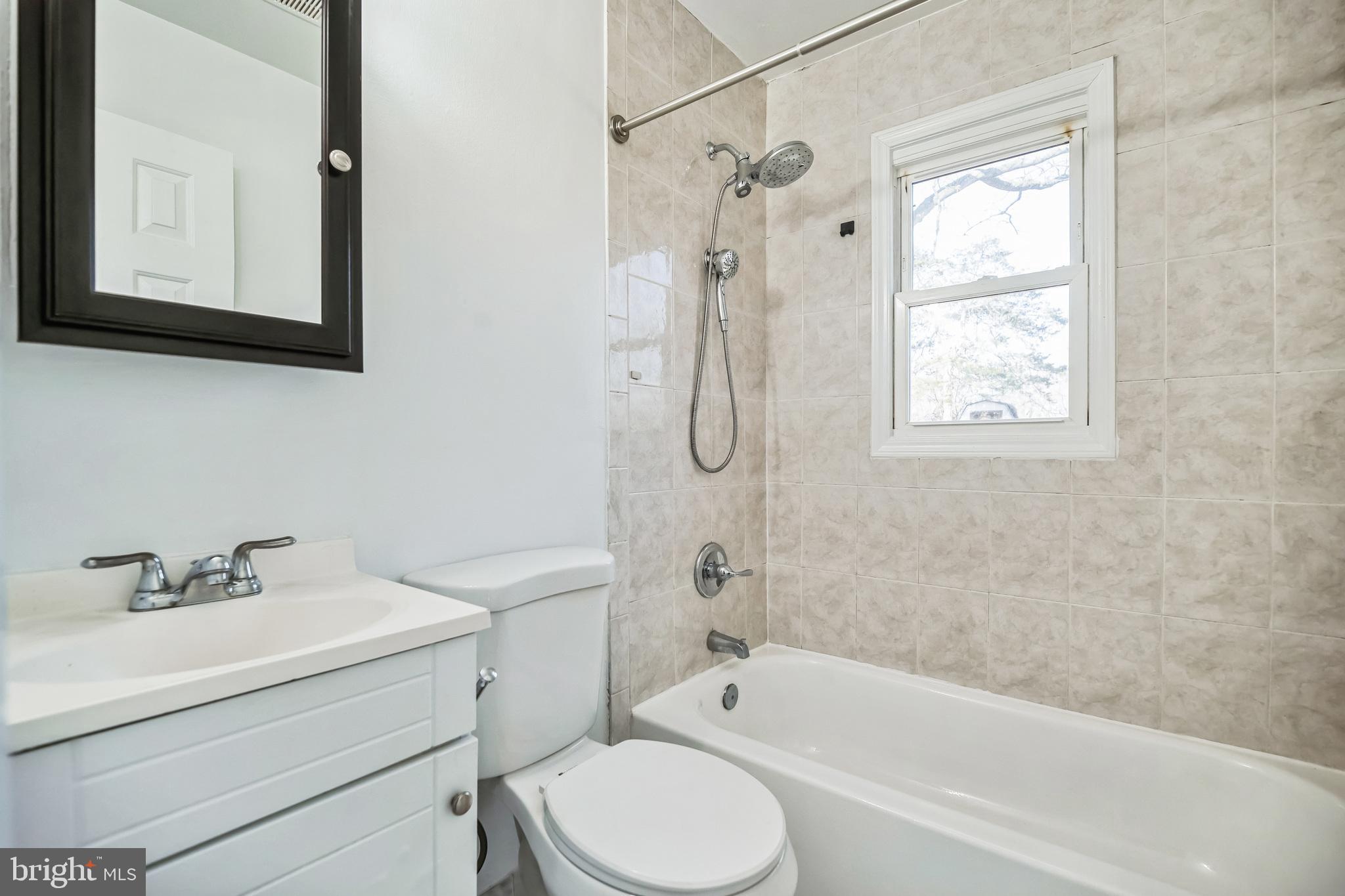 13426 Greenacre Drive Woodbridge, VA 22191 - Photo 17 of 45 a bathroom with a sink toilet and shower