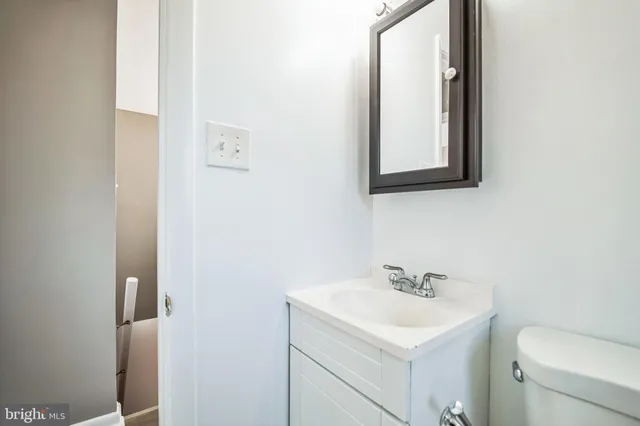 a bathroom with a white bath tub sitting next to a window