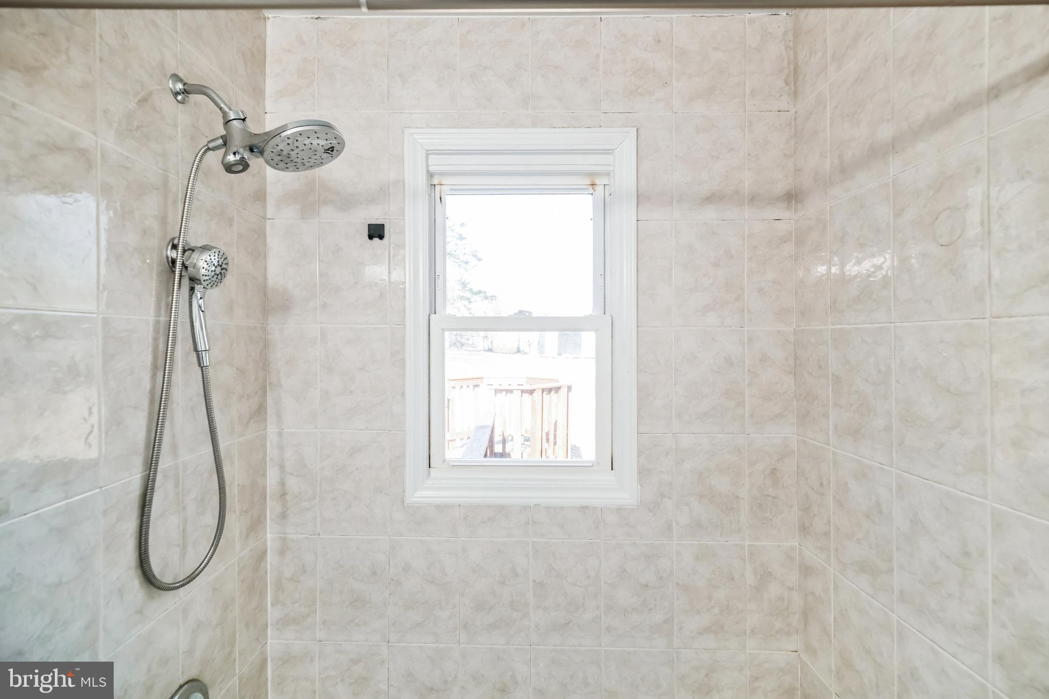 13426 Greenacre Drive Woodbridge, VA 22191 - Photo 23 of 45 a bathroom with a white bath tub sitting next to a window