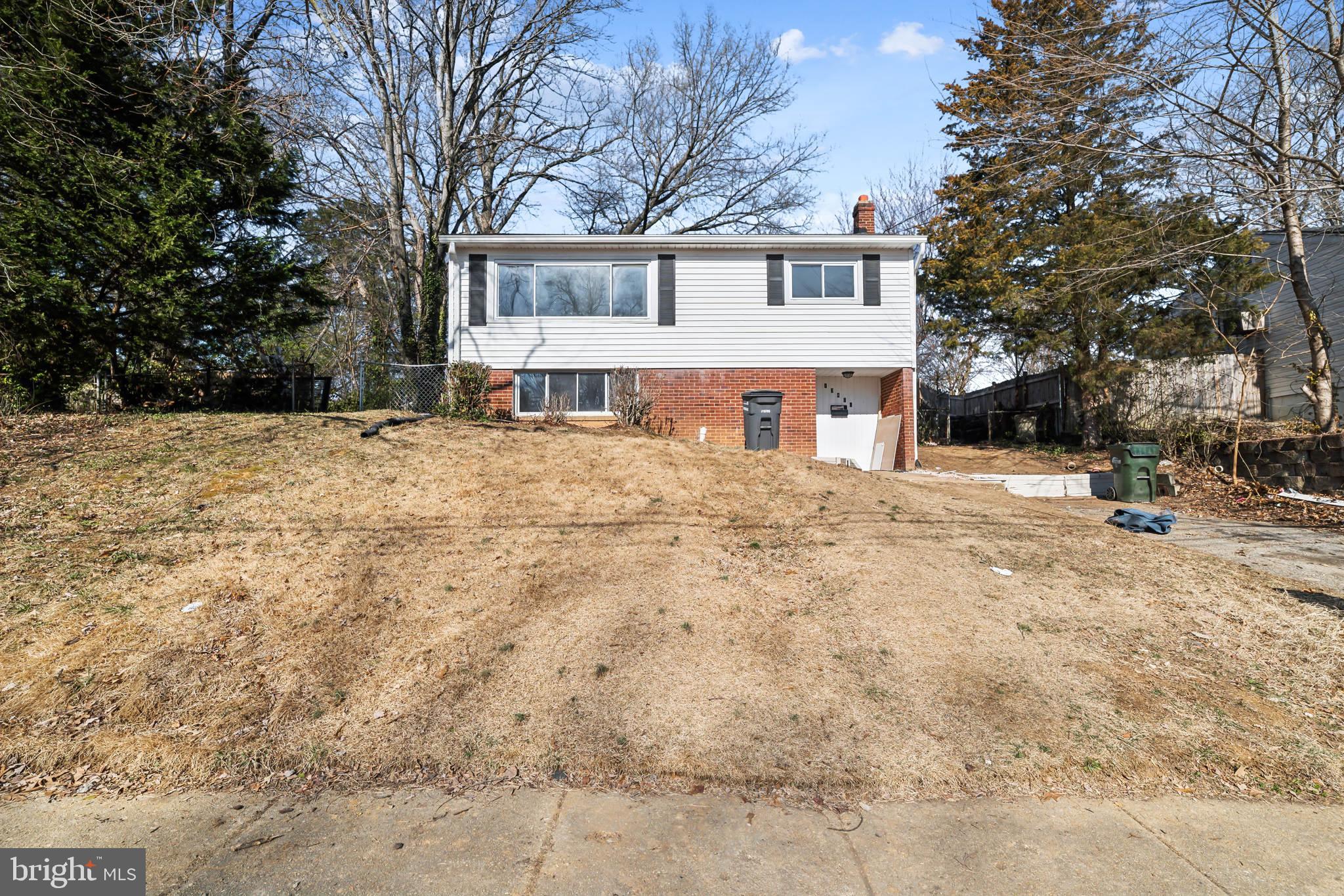 13426 Greenacre Drive Woodbridge, VA 22191 - Photo 25 of 45 a front view of a house with a yard covered in snow