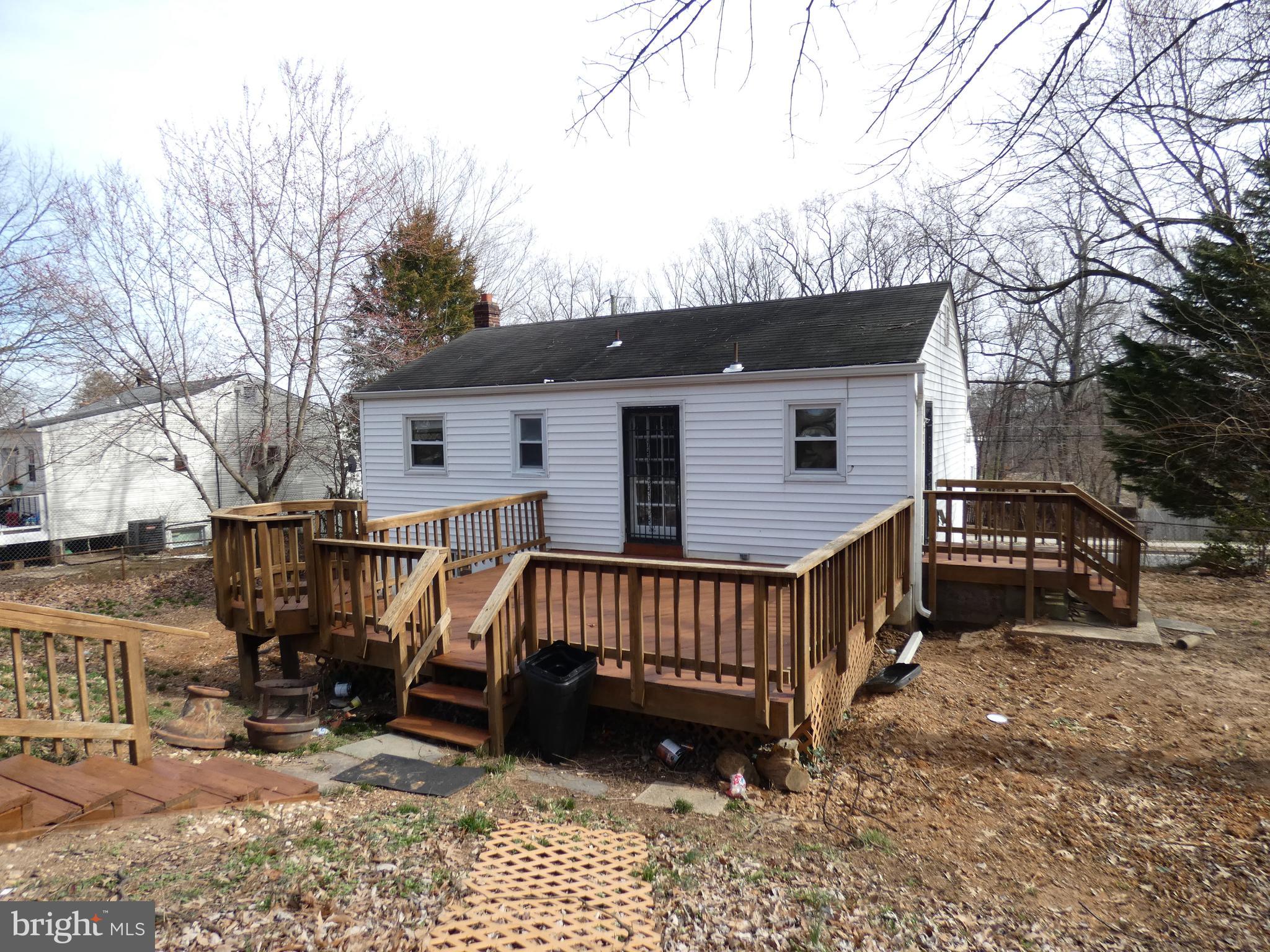 13426 Greenacre Drive Woodbridge, VA 22191 - Photo 29 of 45 a view of a house with wooden deck and furniture