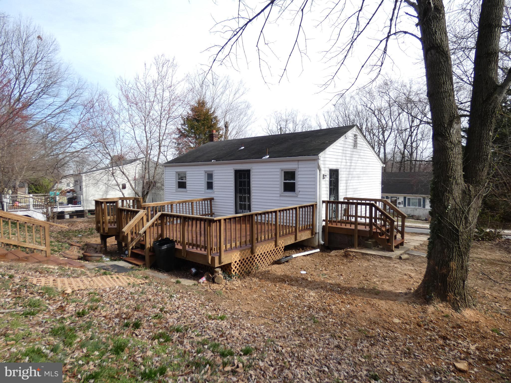 13426 Greenacre Drive Woodbridge, VA 22191 - Photo 33 of 45 a view of a house with a yard covered in snow