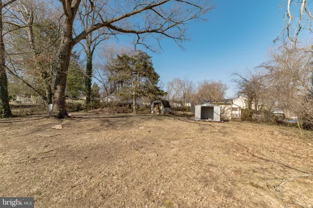 a view of a house with a yard covered in snow