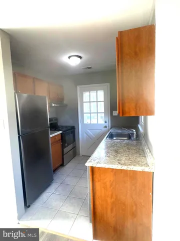 a kitchen with a stove and a refrigerator