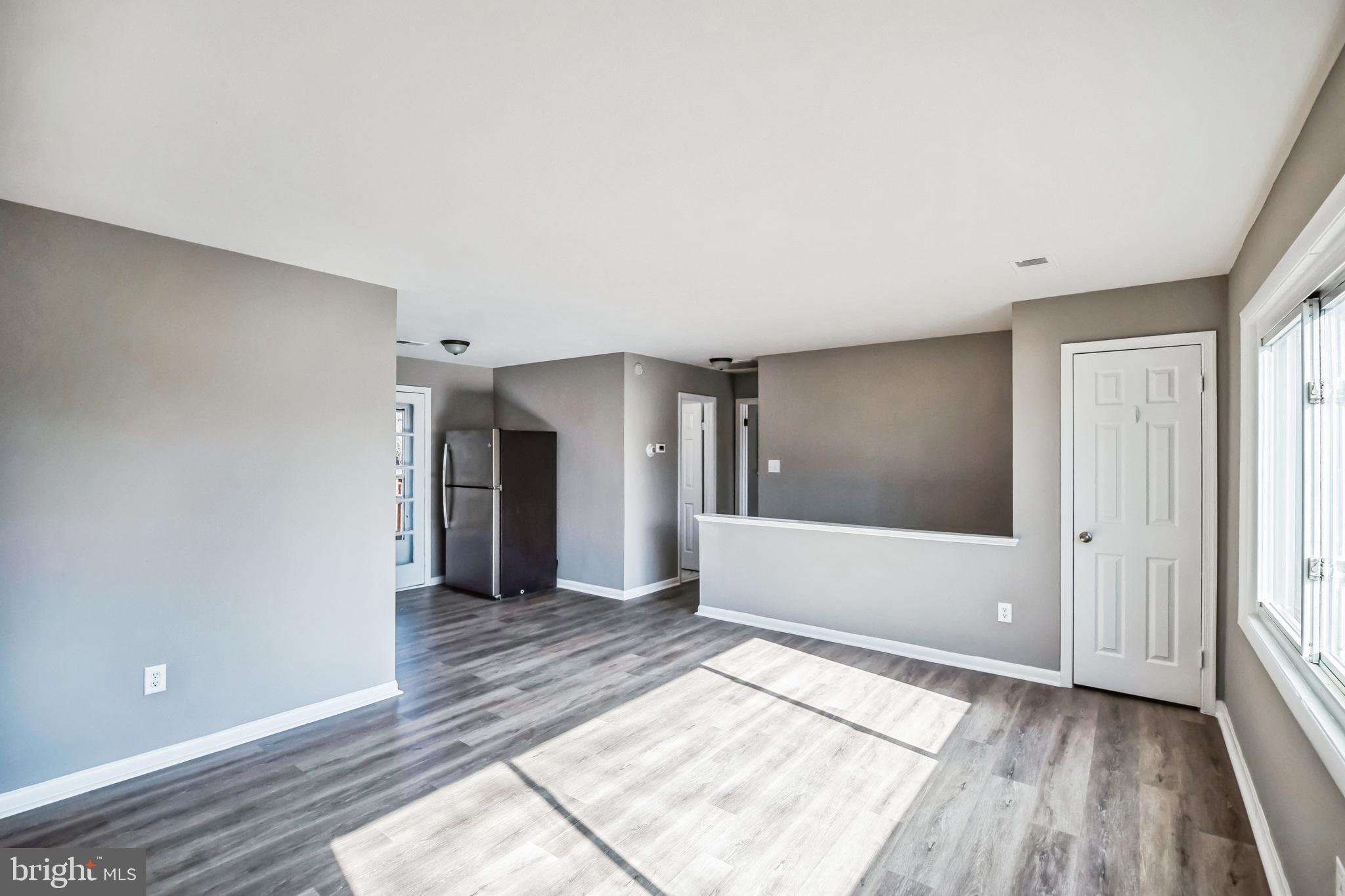 13426 Greenacre Drive Woodbridge, VA 22191 - Photo 5 of 45 a view of a big room with wooden floor and windows