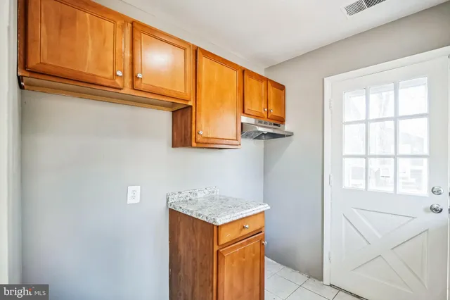 a view of a kitchen with microwave and cabinets