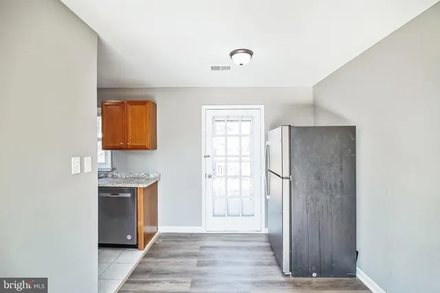 a view of a kitchen with a sink and a refrigerator