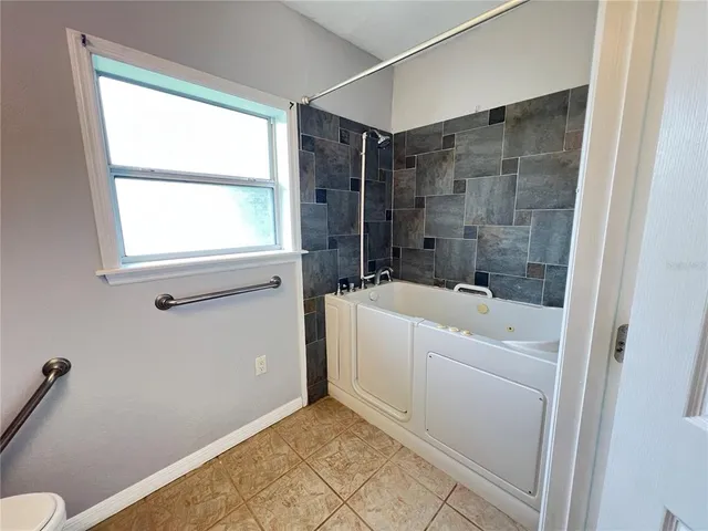 a bathroom with a bathtub a toilet a sink and a shower