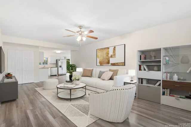 a living room with furniture and a wooden floor