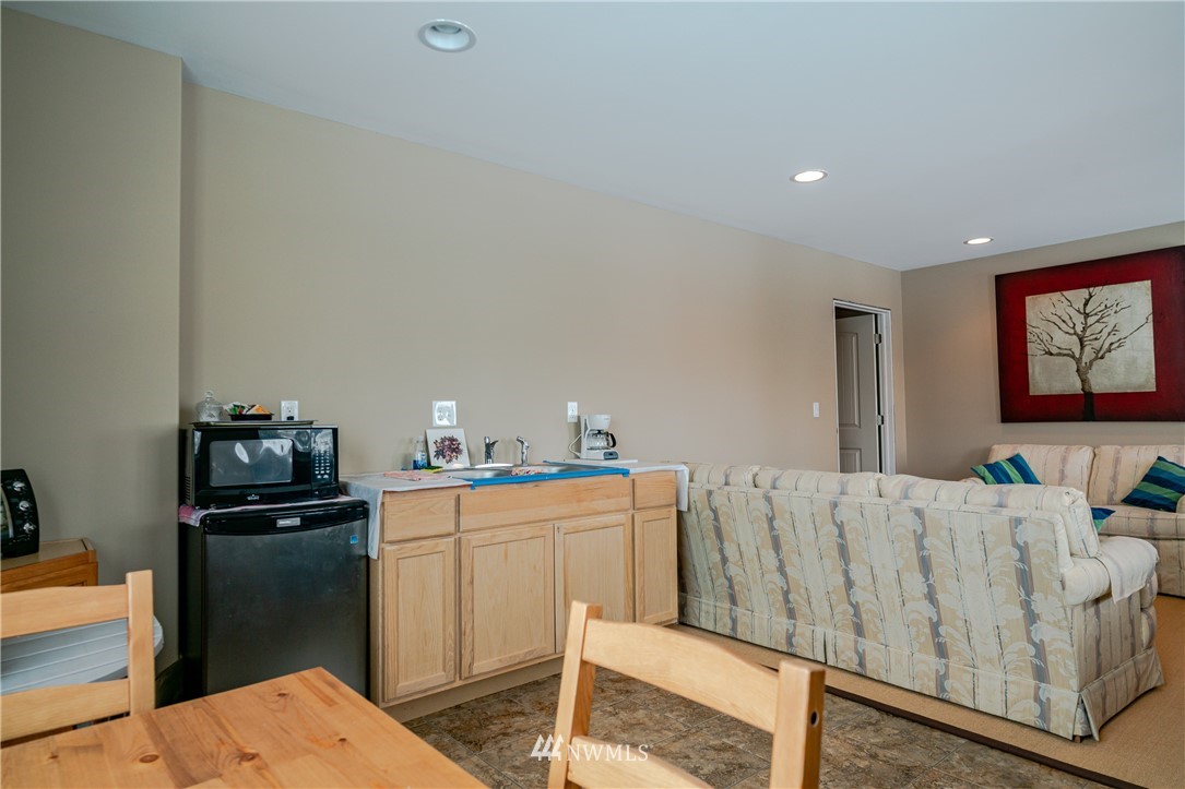 100 Burma Road Methow, WA 98834 - Photo 22 of 36 a kitchen with stainless steel appliances kitchen island a refrigerator sink and wooden floor