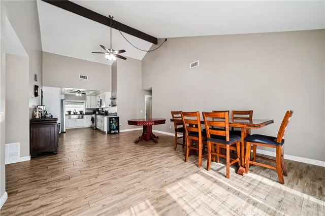 a dining room with furniture and wooden floor