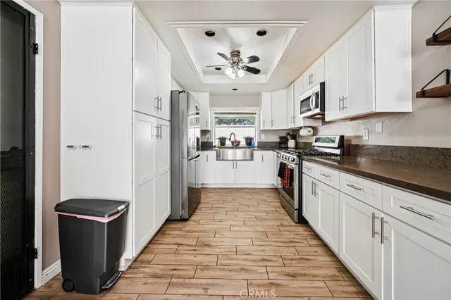 a kitchen with stainless steel appliances granite countertop a refrigerator and a stove top oven