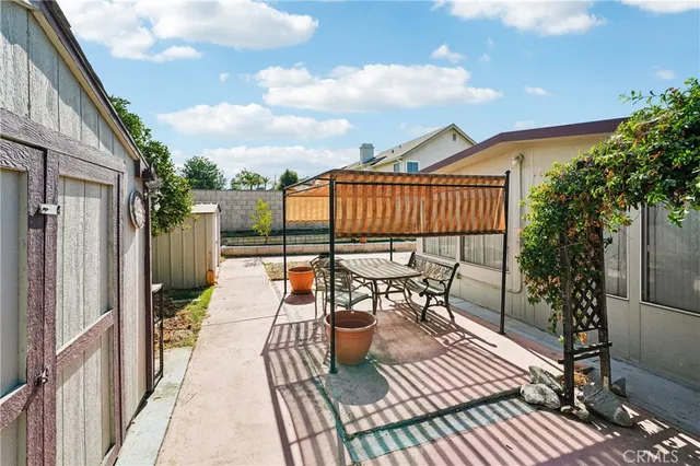 a view of a patio with couches chairs and potted plants