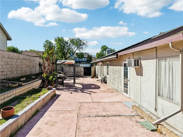 a view of a house with backyard and sitting area