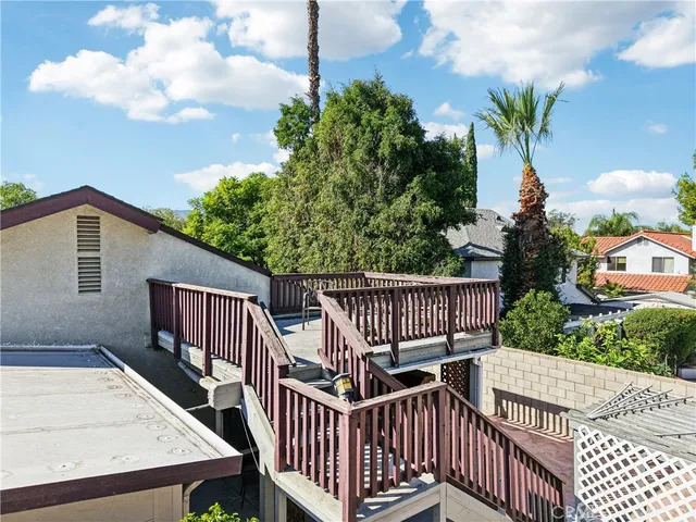 a view of a wooden deck with furniture