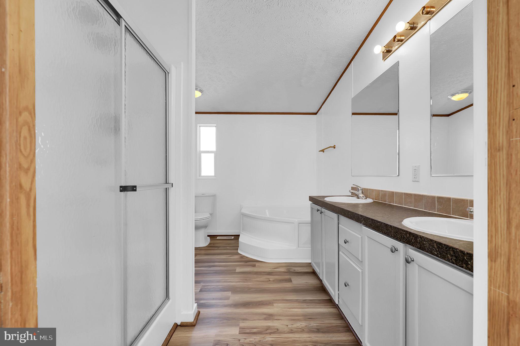 7810 Clark Road, Unit D88 Jessup, MD 20794 - Photo 15 of 30 a bathroom with a granite countertop sink a toilet and shower