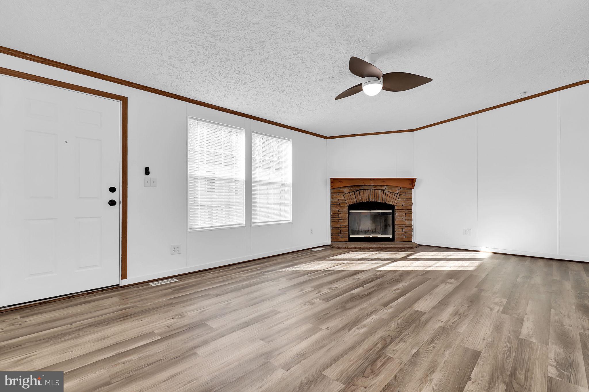 7810 Clark Road, Unit D88 Jessup, MD 20794 - Photo 5 of 30 a view of an empty room with a window and fireplace