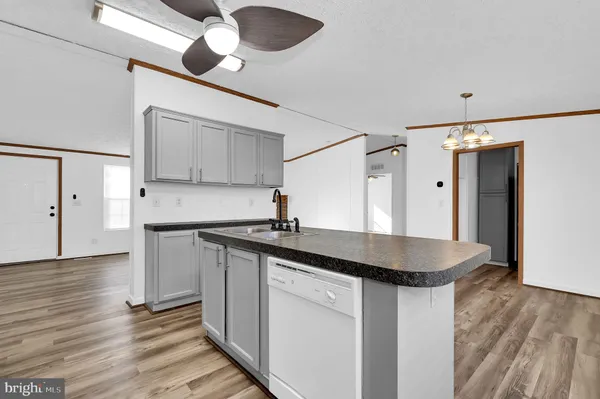 a kitchen with stainless steel appliances granite countertop a sink and a refrigerator