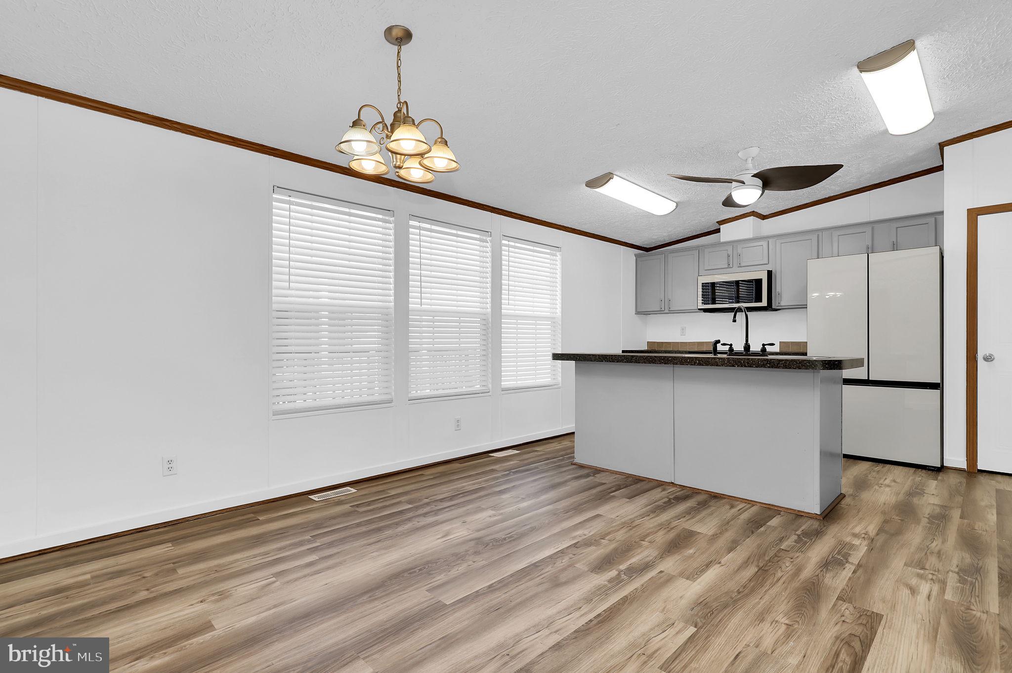 7810 Clark Road, Unit D88 Jessup, MD 20794 - Photo 10 of 30 a view of an empty room with kitchen and a window