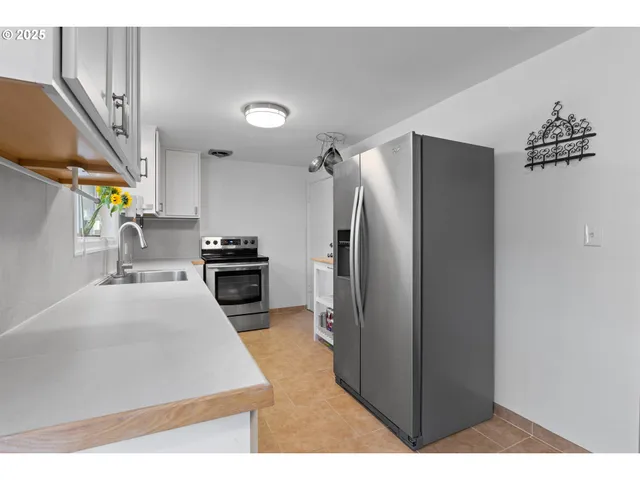 a kitchen with stainless steel appliances a refrigerator and a sink