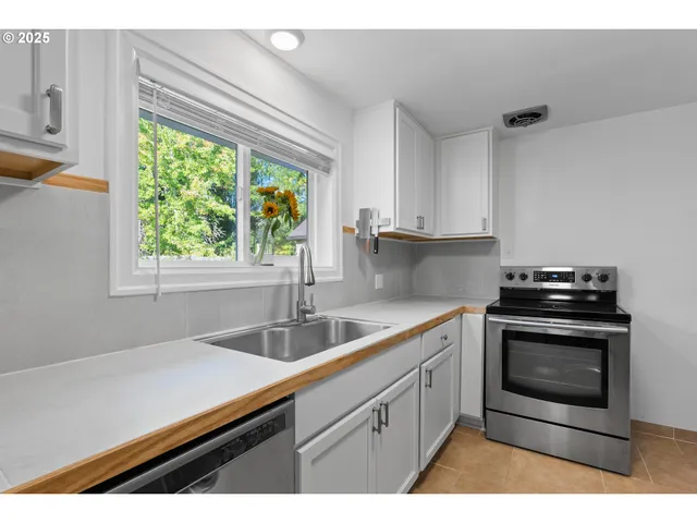 a kitchen with a sink stove and microwave