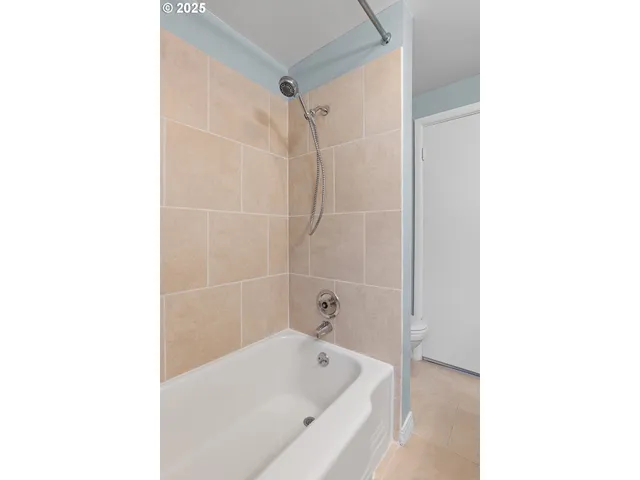 a bathroom with a bathtub and shower