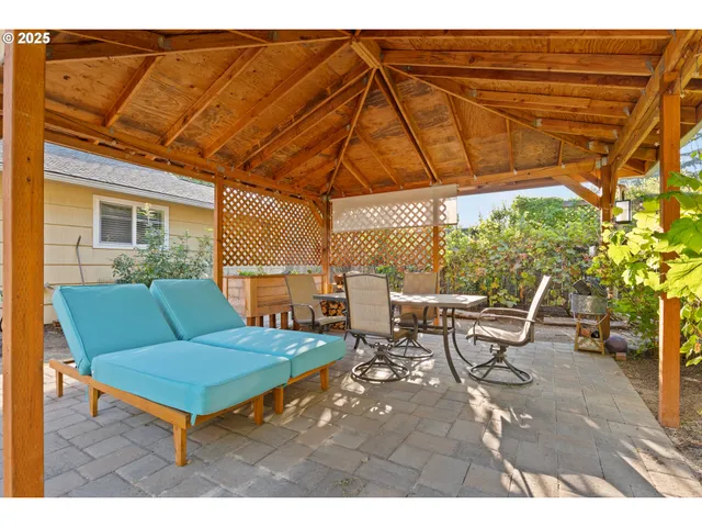 a backyard of a house with table and chairs