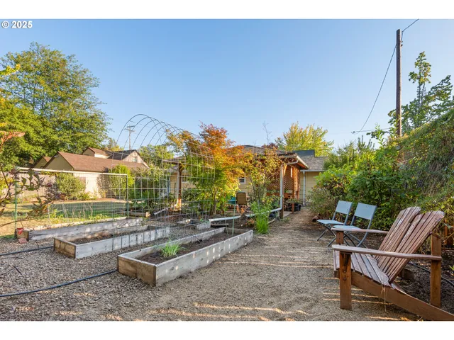 a backyard of a house with table and chairs