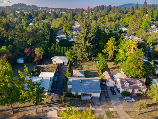 an aerial view of a house with a yard basket ball court and outdoor seating