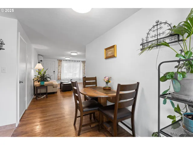 a view of a dining room with furniture and a potted plant