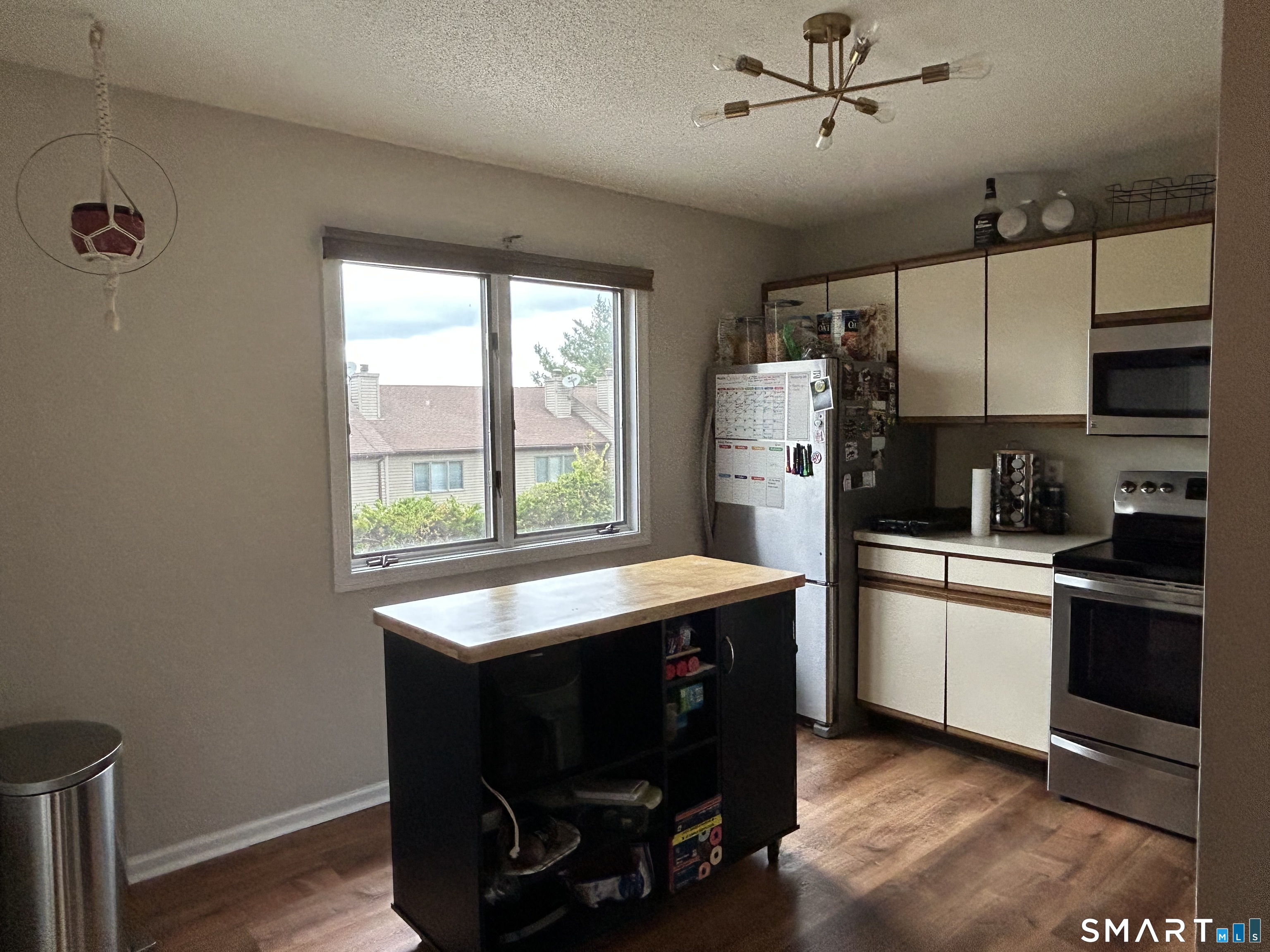 a kitchen with refrigerator cabinets and wooden floor