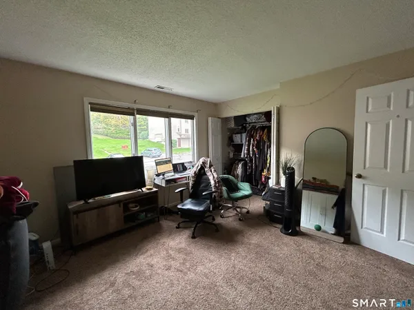 a view of a livingroom with workspace and a couch