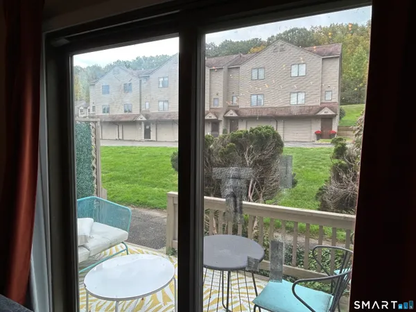 a view of a room with a furniture in balcony