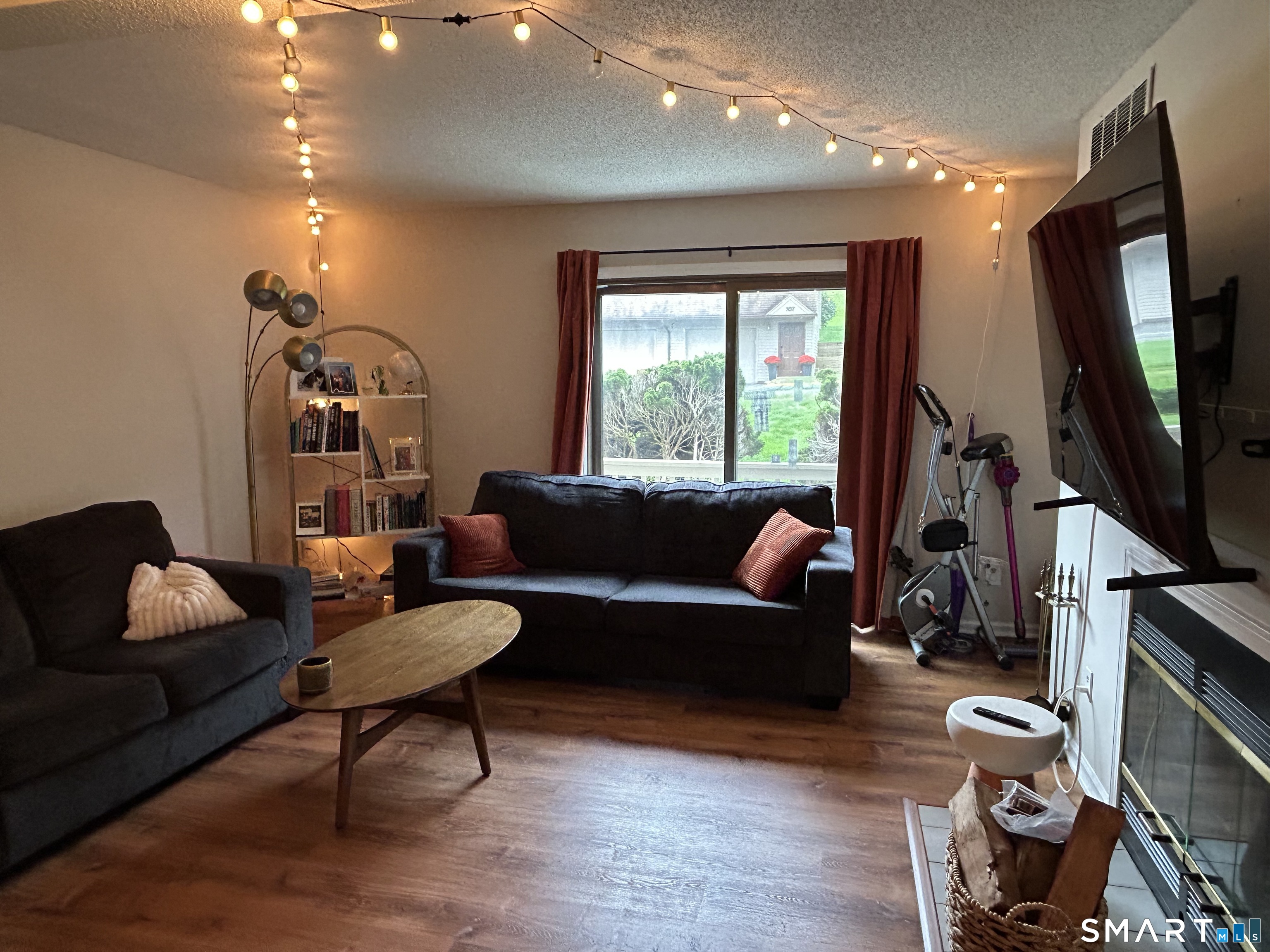 489 Wolcott Street, Unit 85 Bristol, CT 06010 - Photo 8 of 13 a living room with furniture and a flat screen tv