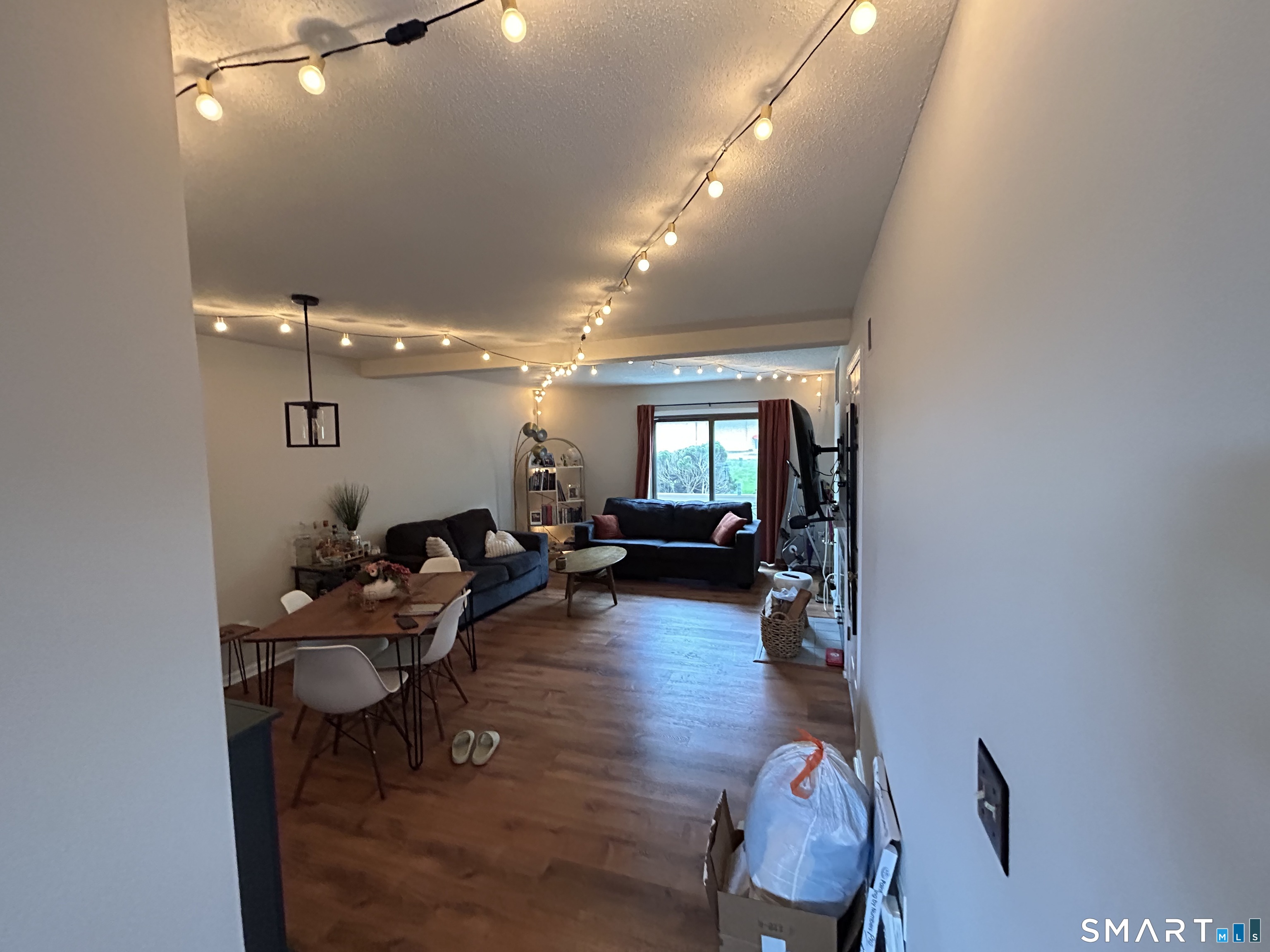 489 Wolcott Street, Unit 85 Bristol, CT 06010 - Photo 9 of 13 a living room with furniture and wooden floor