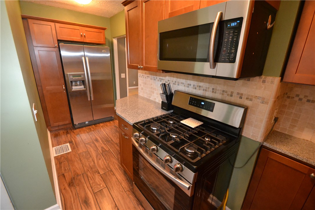723 5 Mile Line Road Webster, NY 14580 - Photo 16 of 38 Stainless appliances and tile flooring