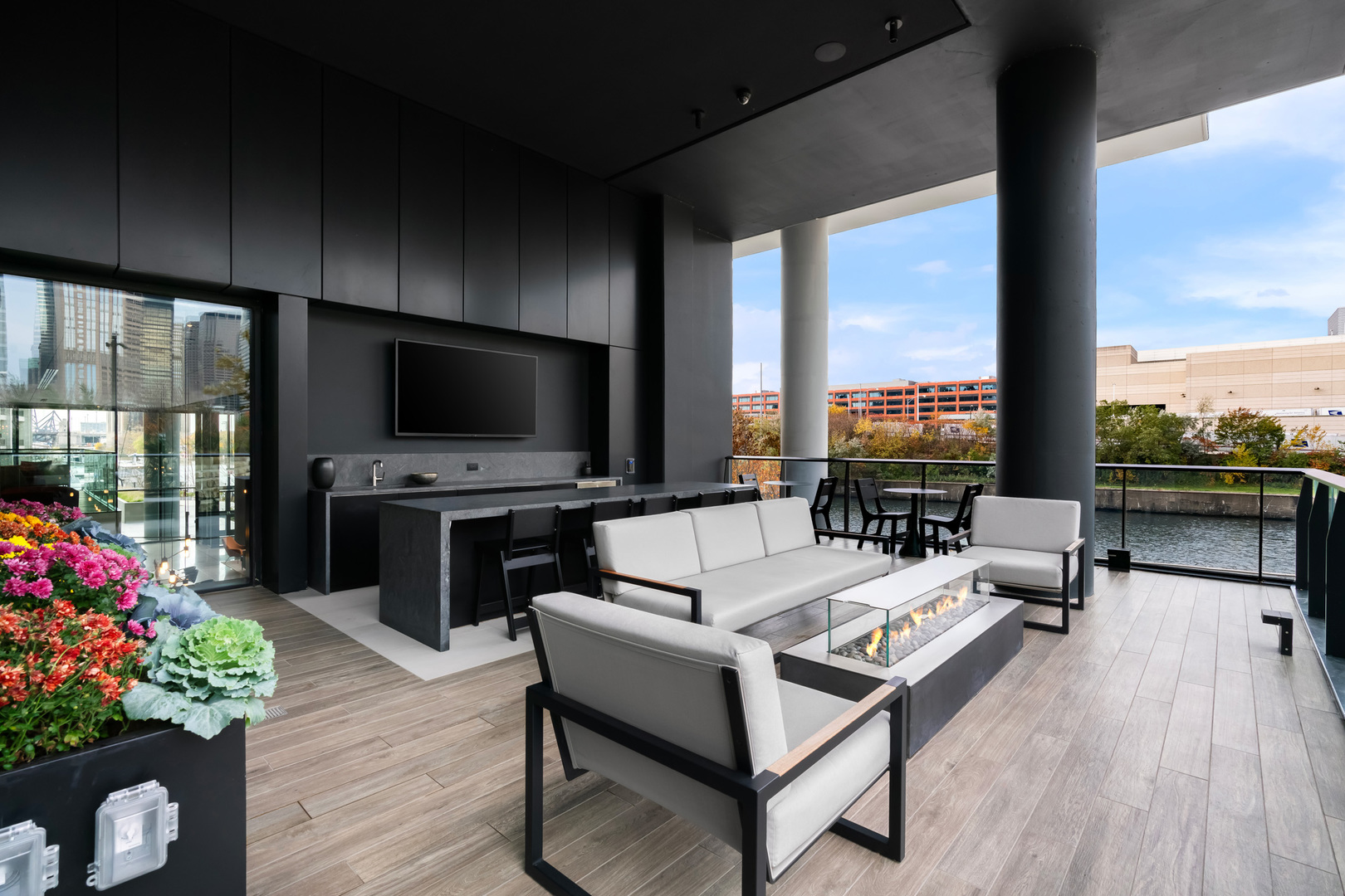 234 West Polk Street, Unit 3704 Chicago, IL 60607 - Photo 13 of 30 a living room with patio furniture and a flat screen tv