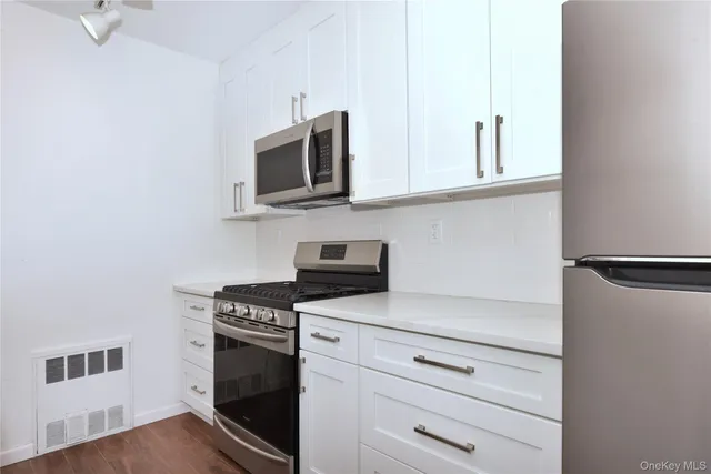 a bathroom with a toilet a sink a shower and mirror