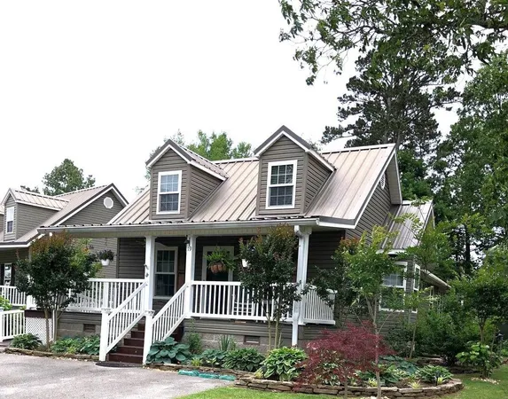 a front view of a house with a garden