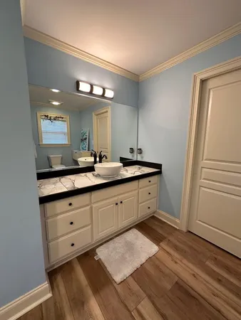 a spacious bathroom with a double vanity sink and a mirror
