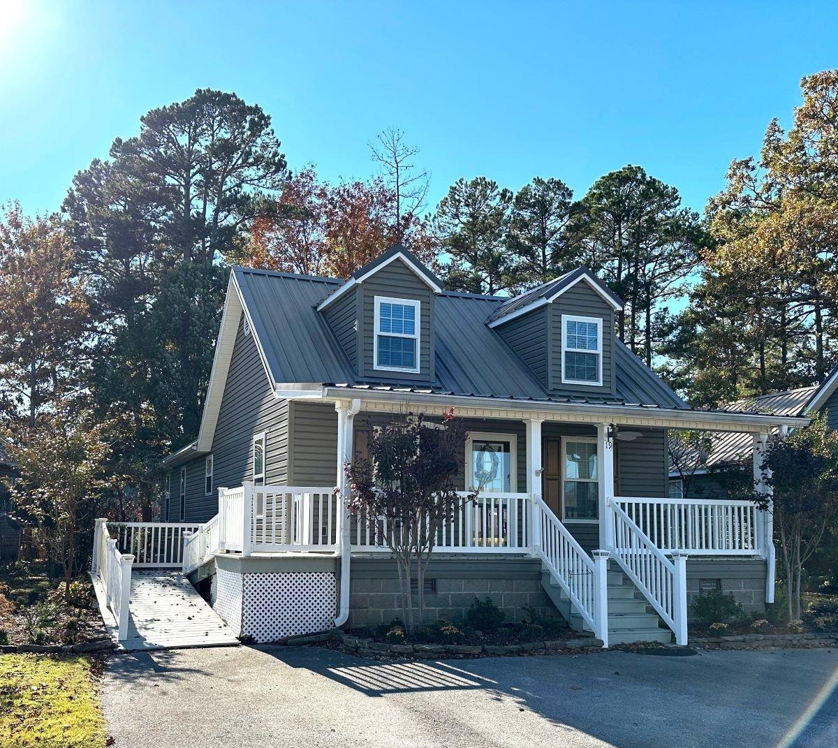 19 Pearl Parkway Iuka, MS 38852 - Photo 21 of 27 a view of a white house with large windows and a small yard